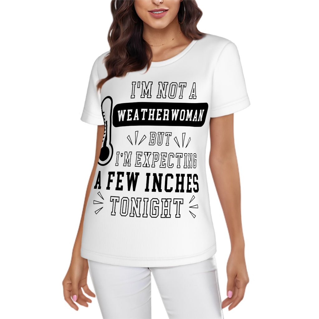 Woman wearing a naughty graphic t-shirt with saying, "I'm not a weatherwoman, but I'm expecting a few inches tonight." Lady dressed in all white pants and t-shirt with black lettering. Naughty graphic swinger tee.