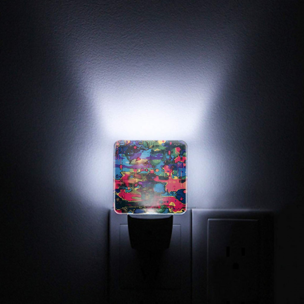 Electric camouflage night light plugged into a wall outlet and lit.
