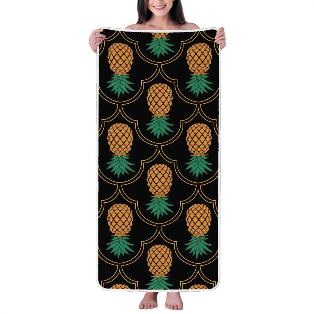 Woman holding up a fancy upside-down pineapple towel.