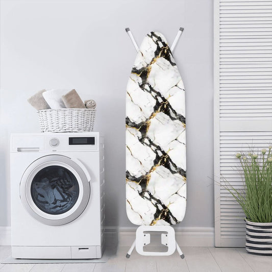 Black and gold marble colored ironing board cover on an ironing board in a laundry room. The ironing board is standing next to a washing machine.