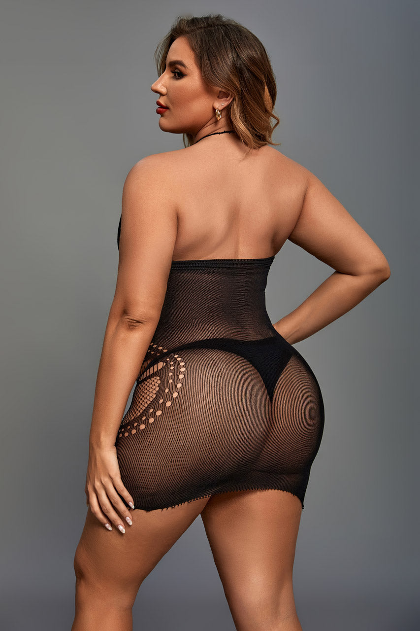 Woman wearing a black sheer bodysuit against a gray background