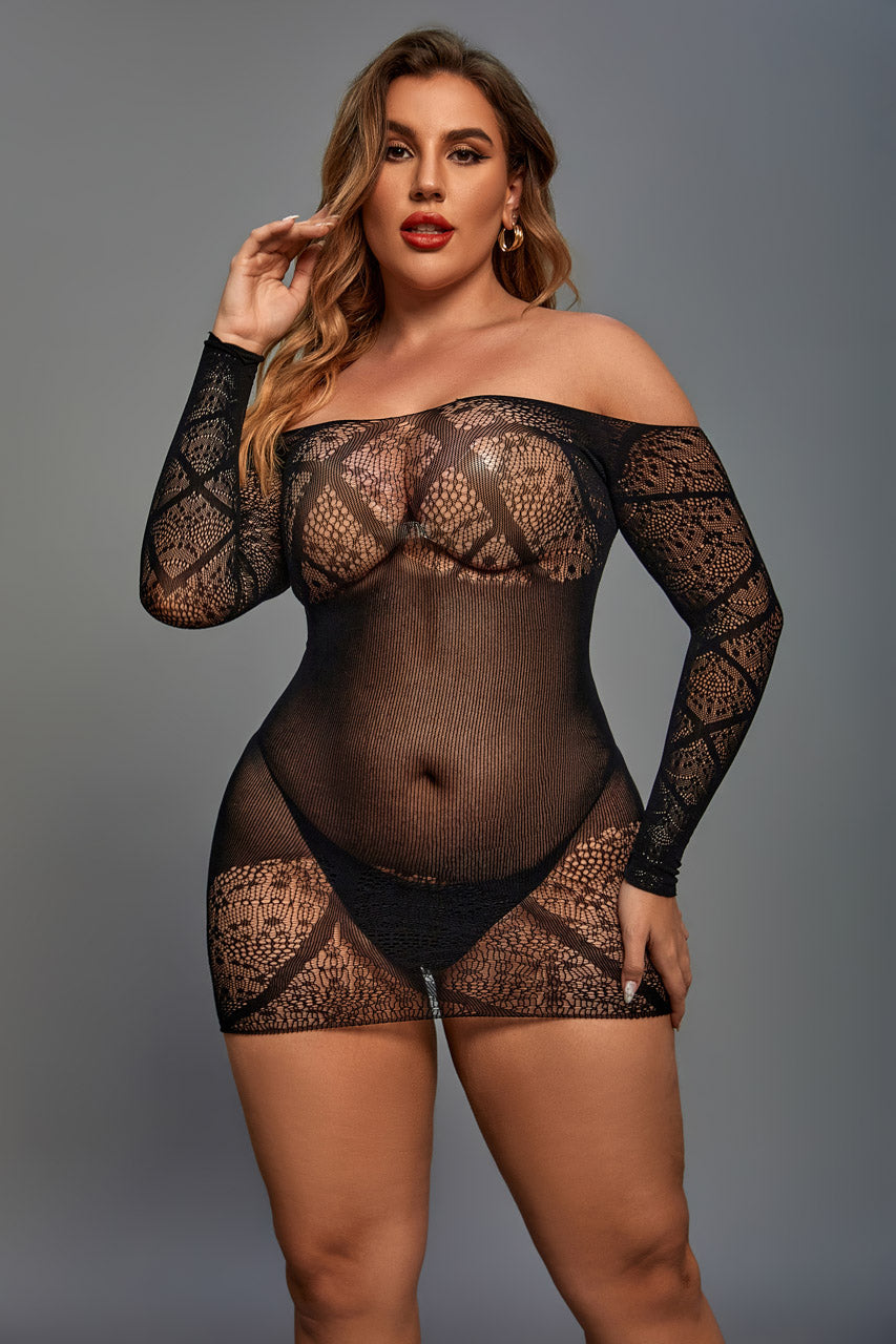 Woman wearing a black lace bodysuit against a gray background