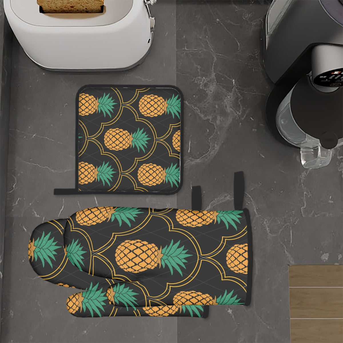 Upside down pineapple 3 piece oven mits sitting on a kitchen counter. Luxurious swinger home goods. 