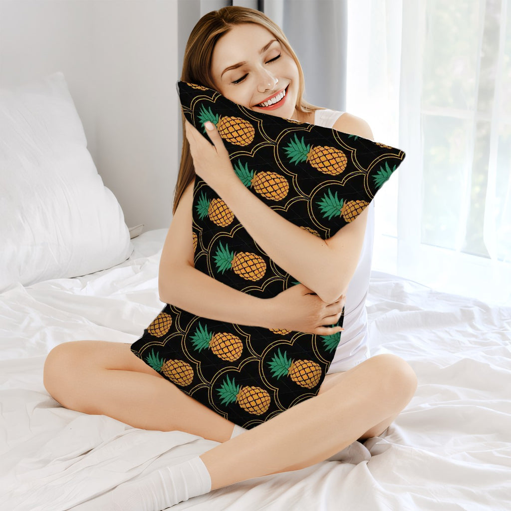 Woman holding an upside down pineapple pillow sitting in bed with a smile on her face. Elegant swinger merchandise.